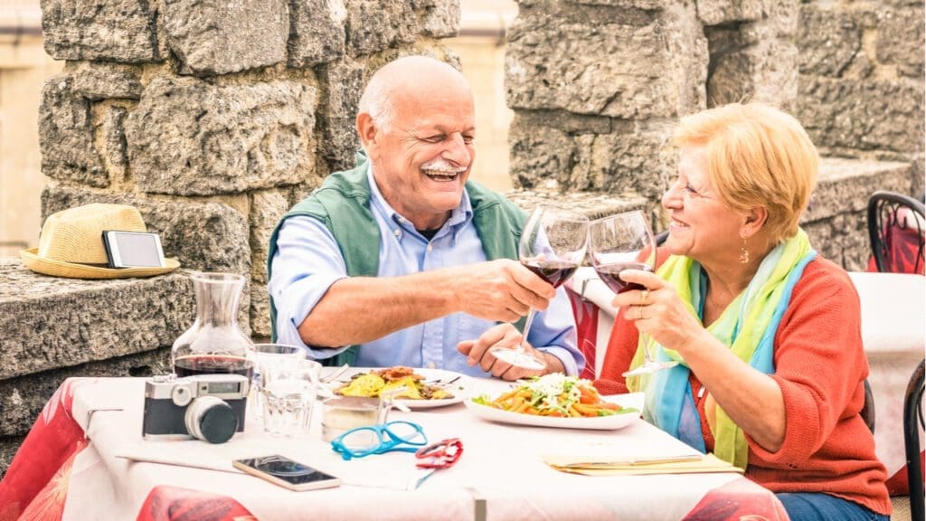 An older couple eating at a restaurant while on holiday