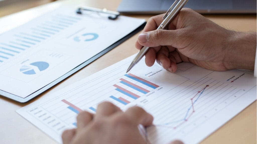 A person reviewing graph data on paper