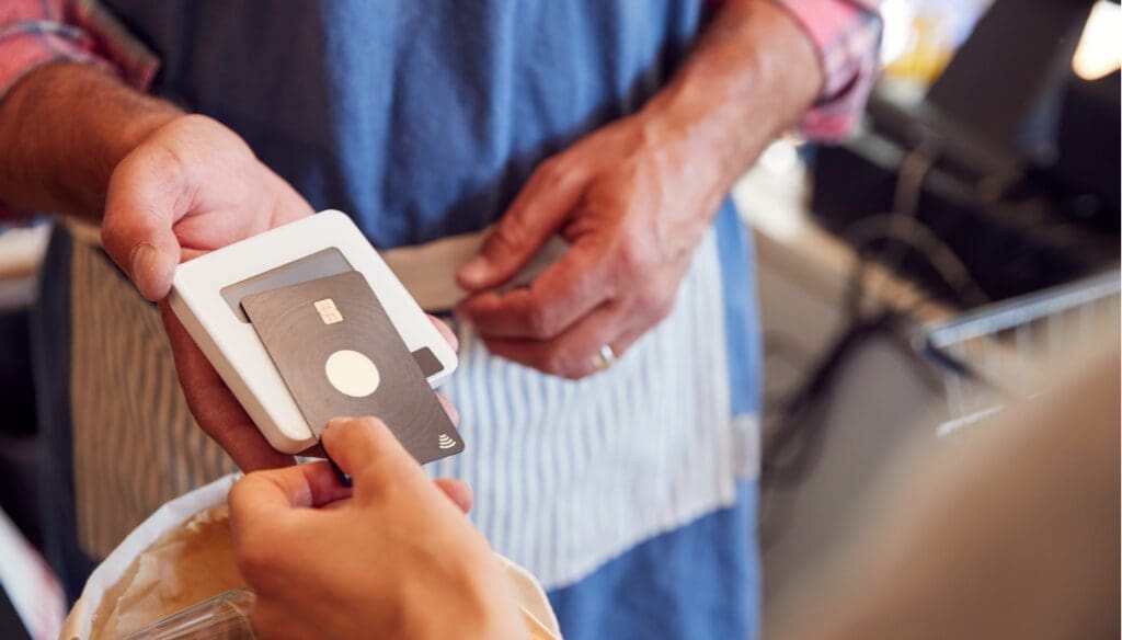 A shopper using contactless payment to pay