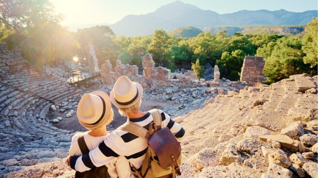 A mature couple enjoying the view of an ancient amphitheatre
