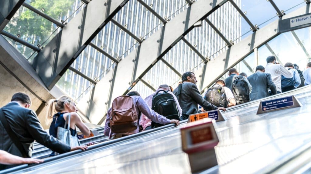 Commuters riding an escalator on the London Underground