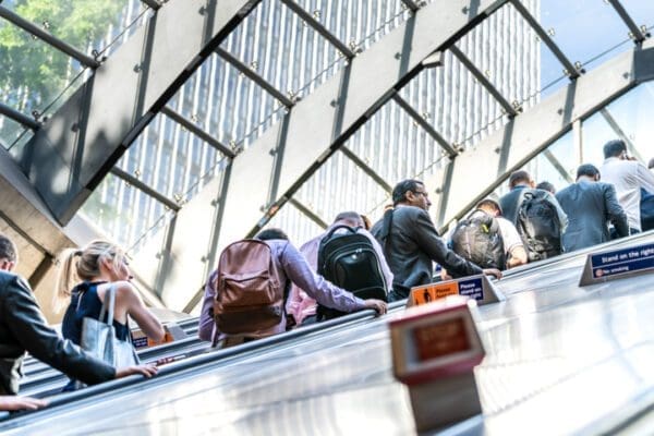 Commuters riding an escalator on the London Underground