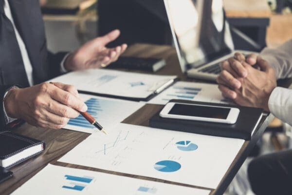 Two people reviewing financial data and graphs